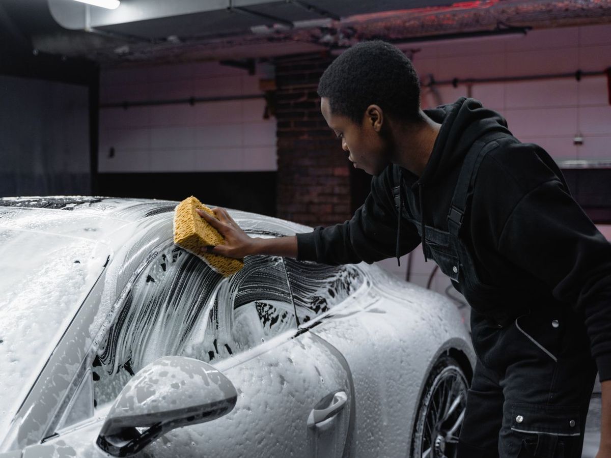 Detailer washing a car by hand